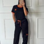CONJUNTO HERMES NEGRO BORDE NARANJA